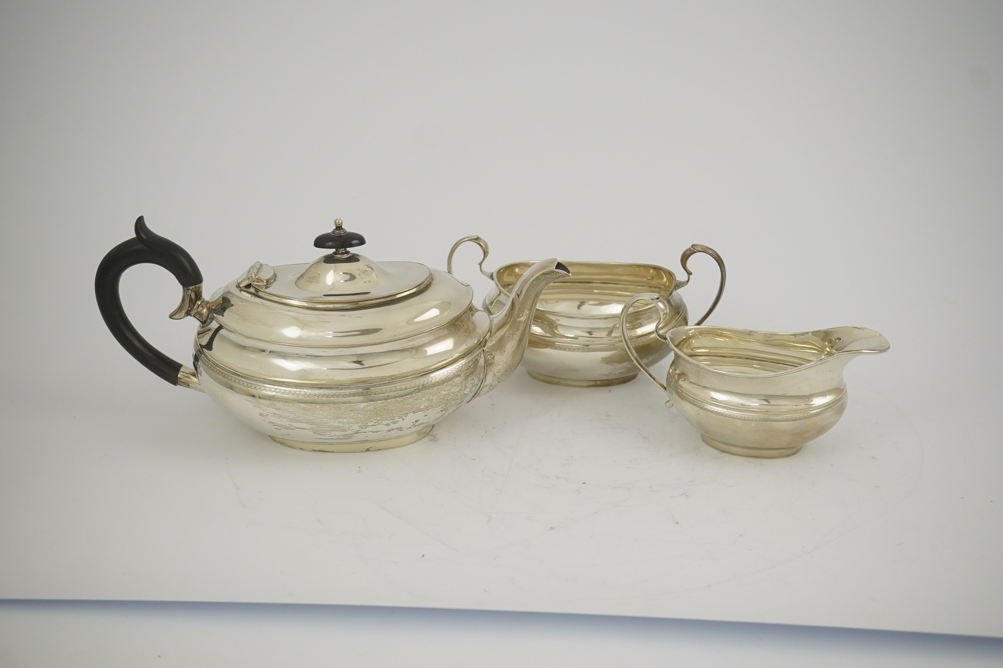 A George V silver three piece oval tea set, by Viners Ltd